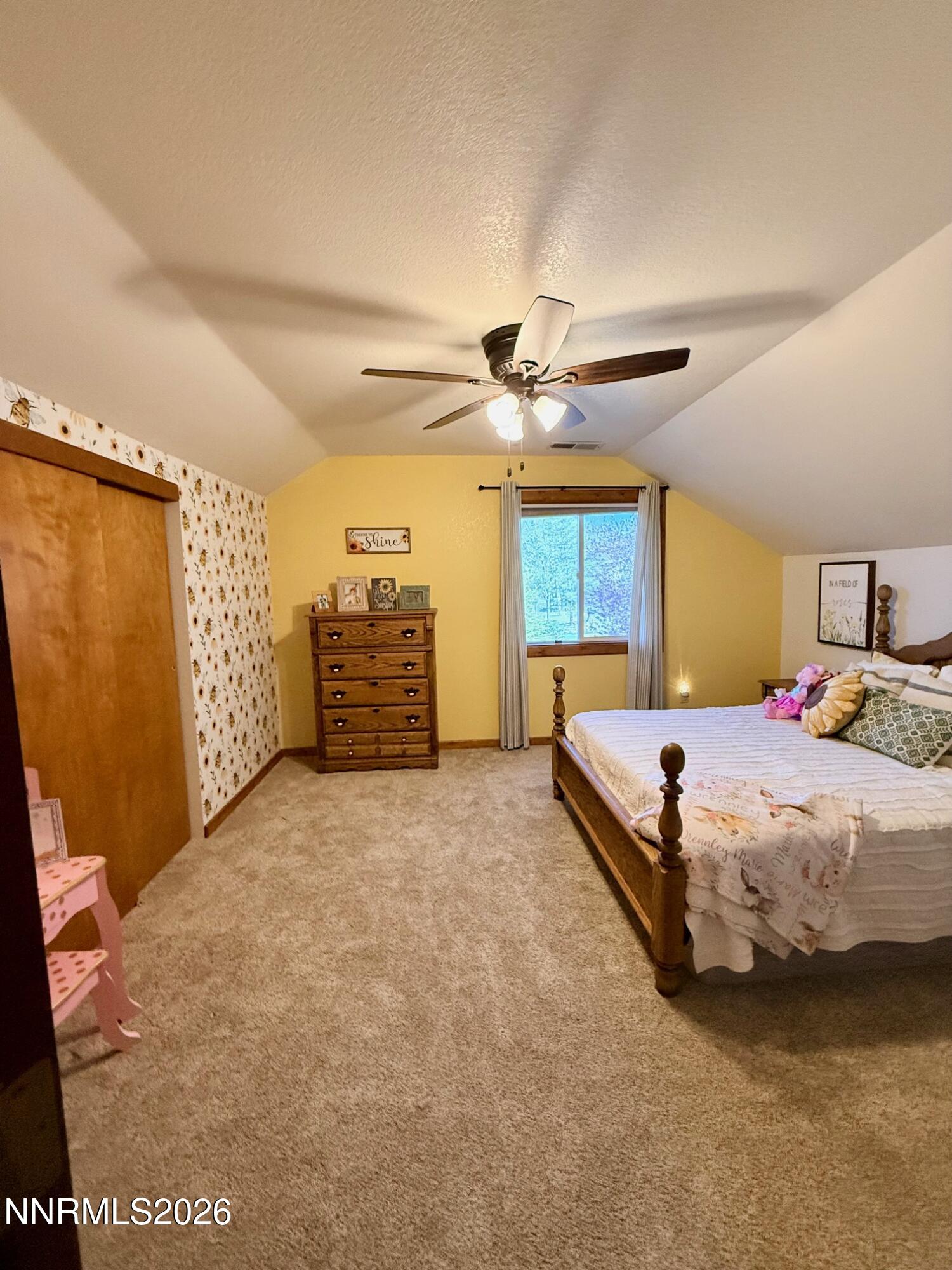 4734 Killdeer Road Carson City, NV 89701 - Photo 36 of 40 a spacious bedroom with a bed and a chandelier