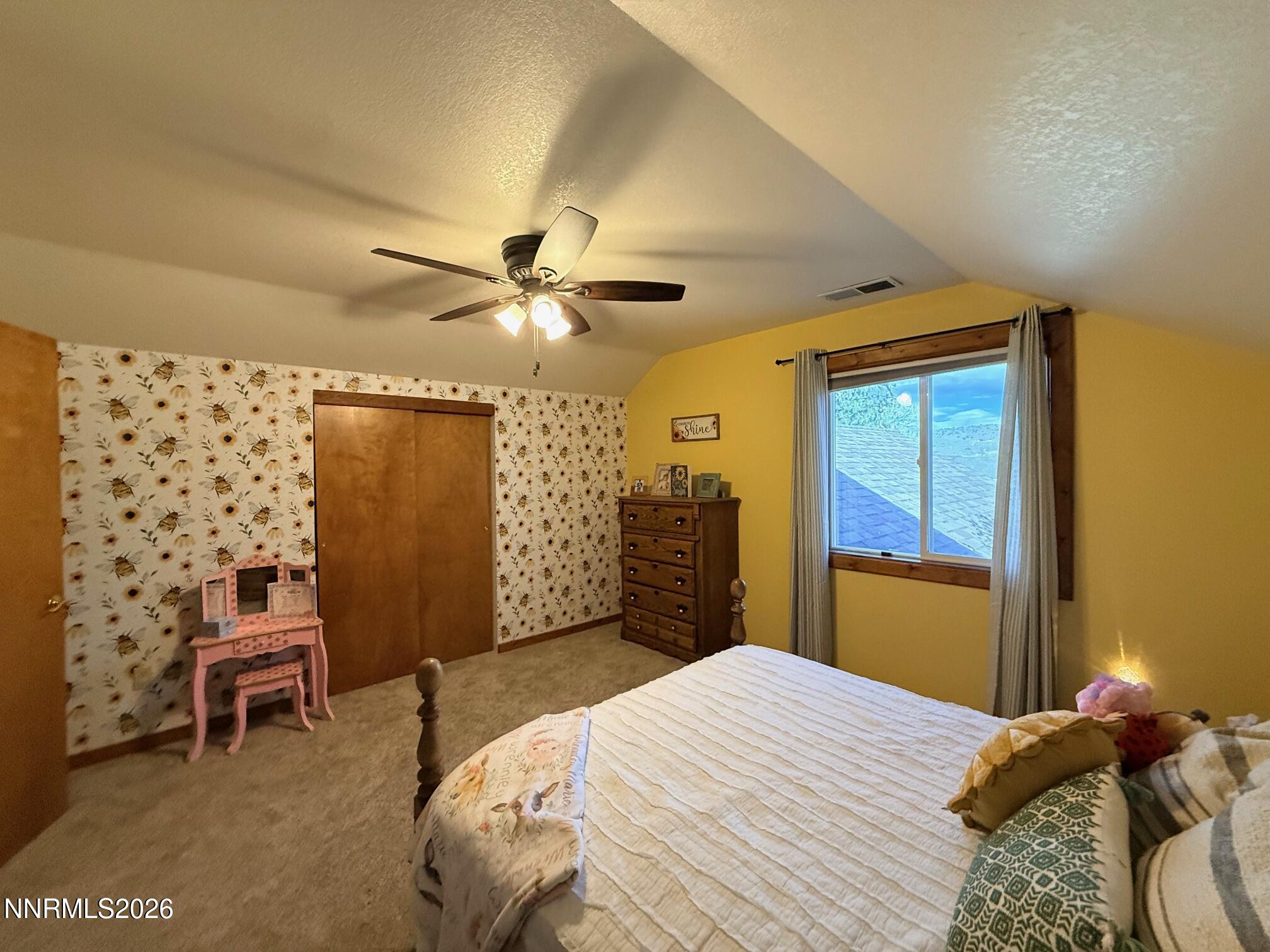 4734 Killdeer Road Carson City, NV 89701 - Photo 37 of 40 a bedroom with a bed dresser and a window