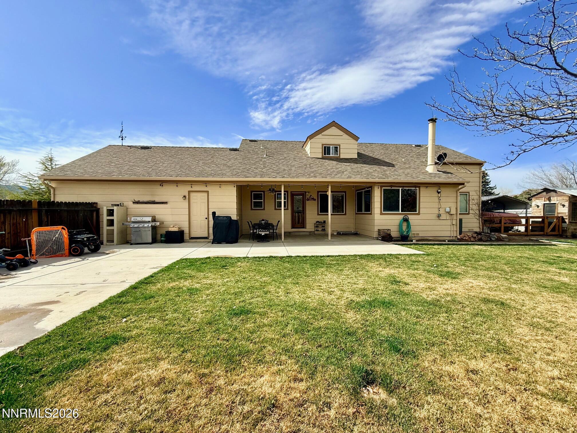 4734 Killdeer Road Carson City, NV 89701 - Photo 8 of 40 a front view of a house with a garden