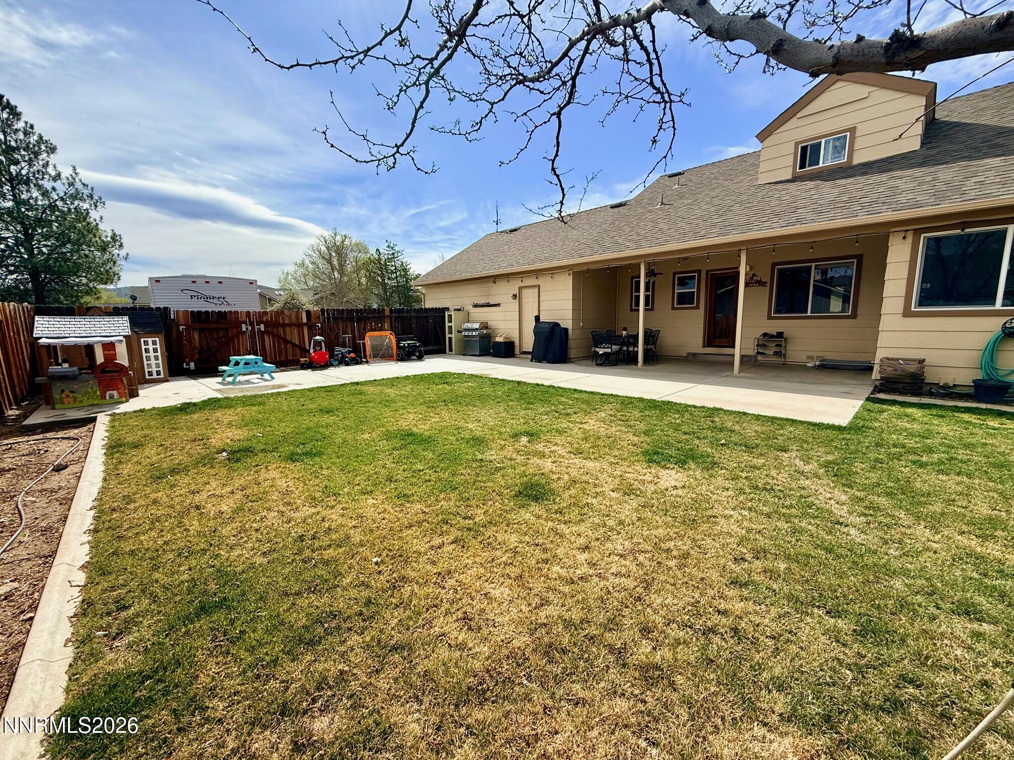 4734 Killdeer Road Carson City, NV 89701 - Photo 10 of 40 a view of a house with a big yard and large trees