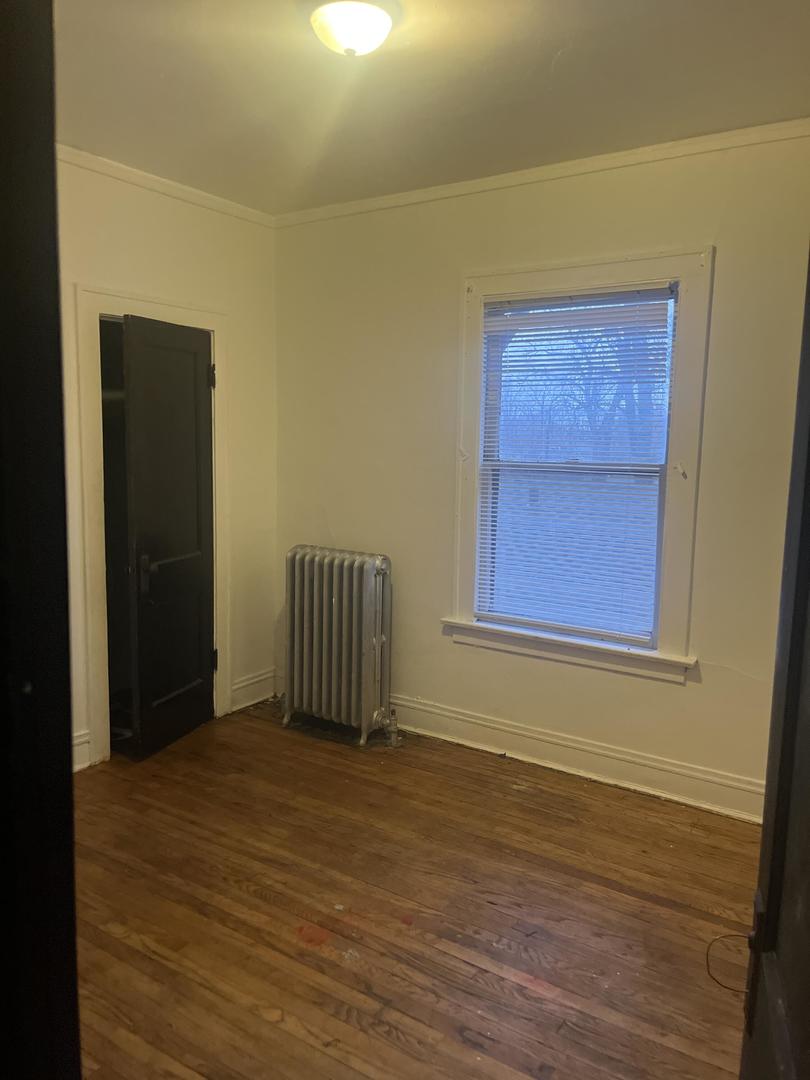 237 West 114th Street Chicago, IL 60628 - Photo 12 of 27 an empty room with wooden floor and windows