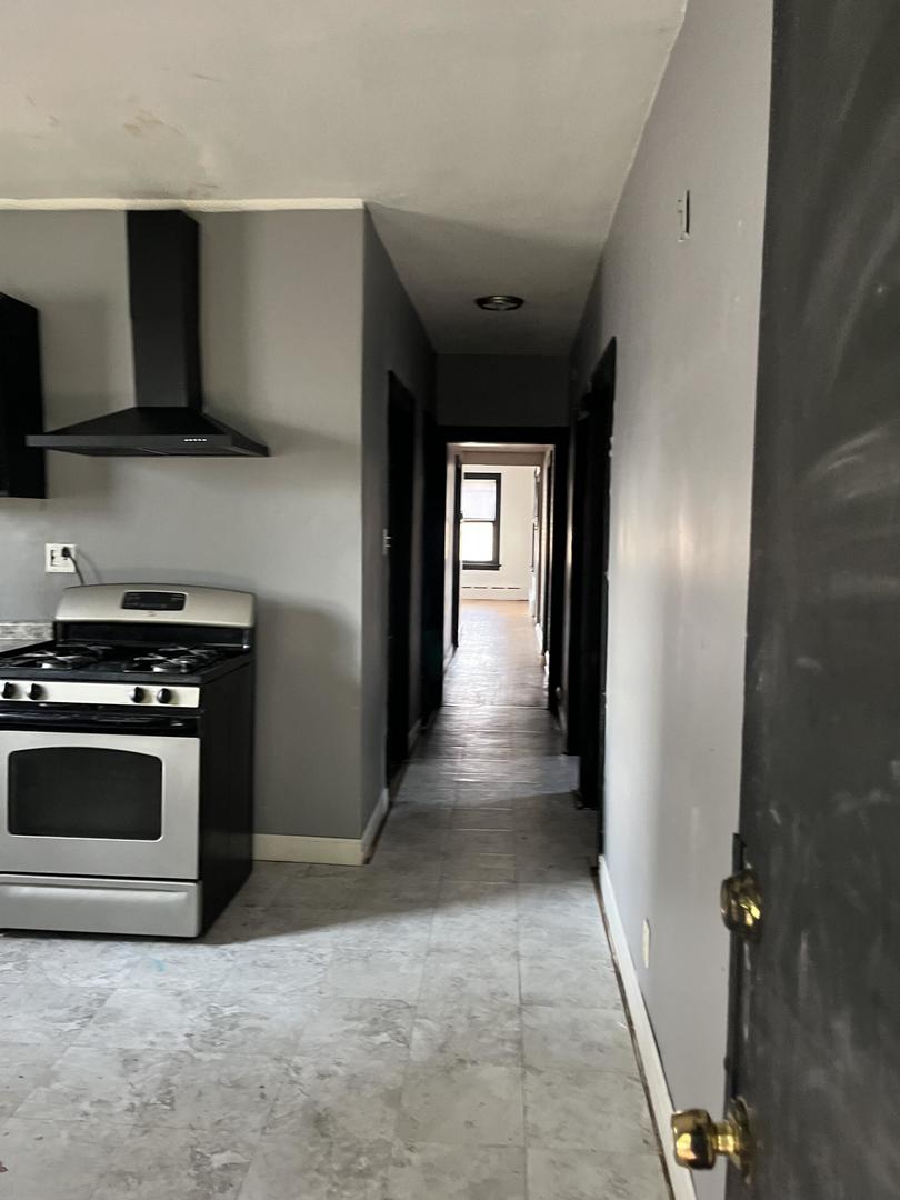 237 West 114th Street Chicago, IL 60628 - Photo 24 of 27 a view of a kitchen from the hallway