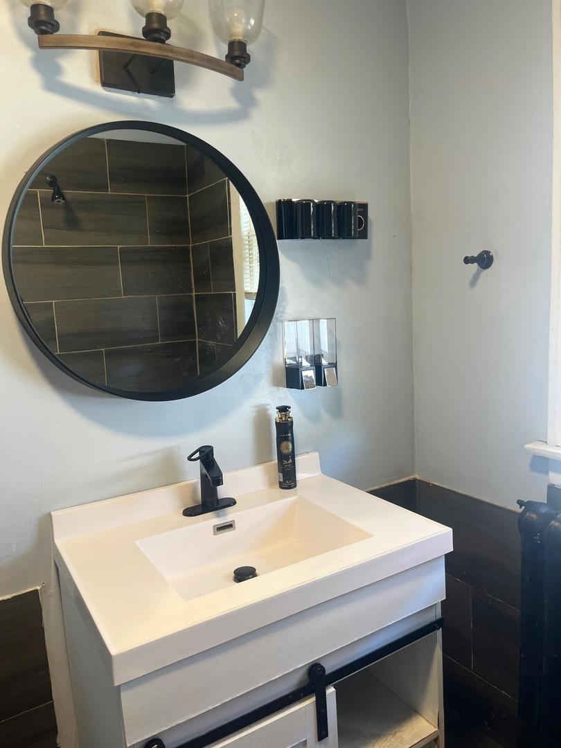 237 West 114th Street Chicago, IL 60628 - Photo 6 of 27 a bathroom with a sink and a mirror