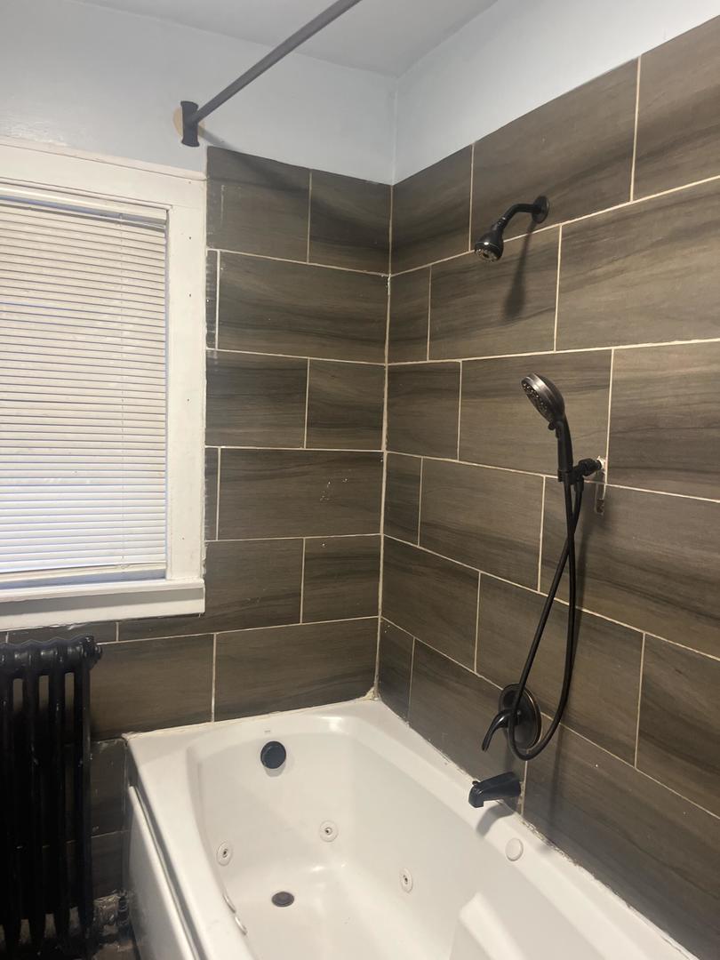 237 West 114th Street Chicago, IL 60628 - Photo 8 of 27 a bathroom with a tub and a shower