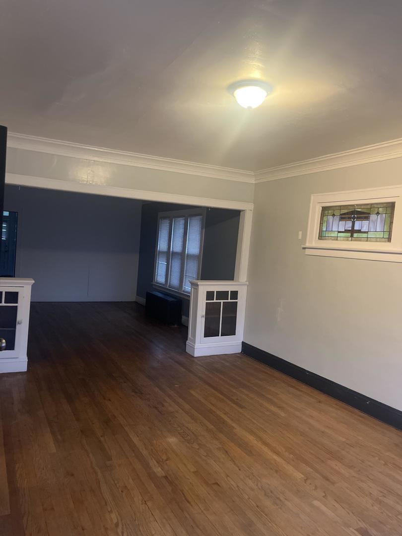 237 West 114th Street Chicago, IL 60628 - Photo 9 of 27 a view of a livingroom with wooden floor
