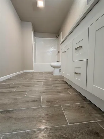 a view of a bathroom with a sink and a mirror