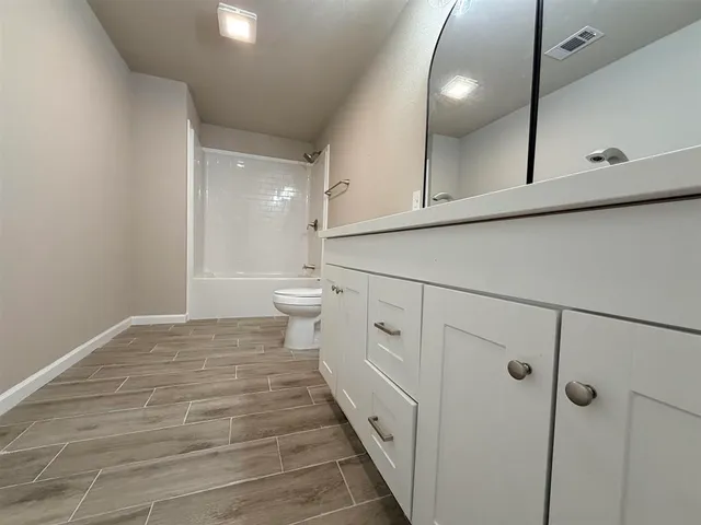 a spacious bathroom with a double vanity sink mirror and