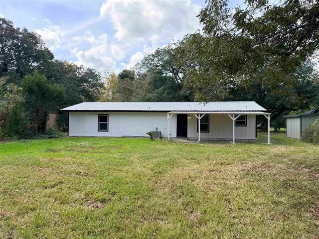 a house that has a tree in front of it