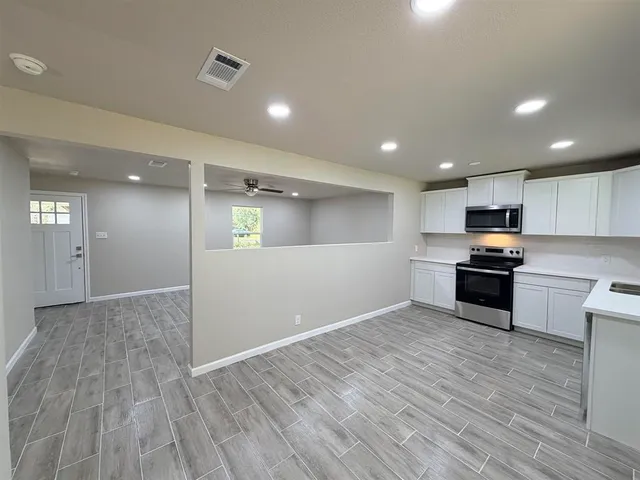 a kitchen with granite countertop a stove and a sink