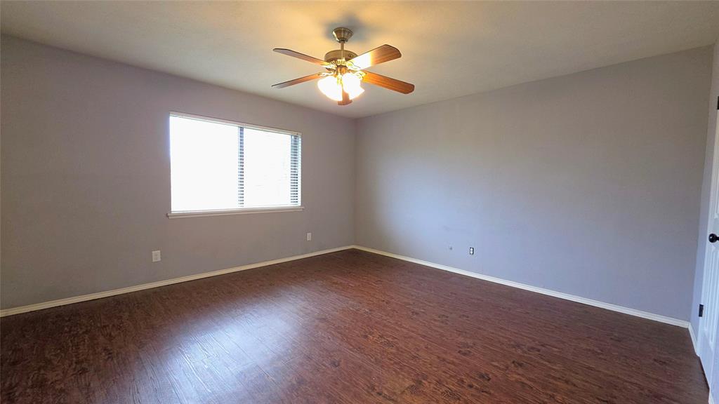 731 Leading Lane Allen, TX 75002 - Photo 11 of 18 an empty room with wooden floor and windows