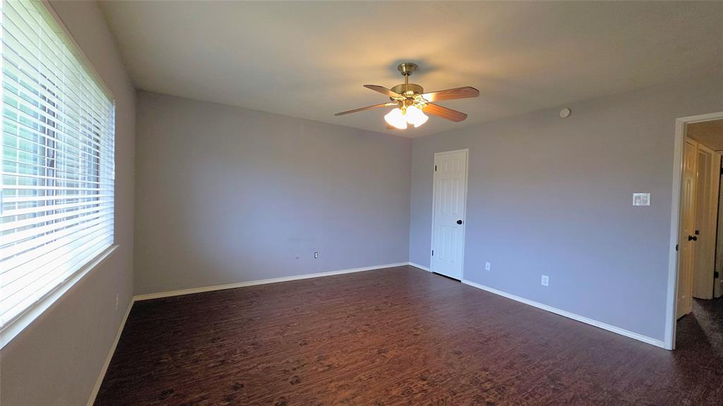 731 Leading Lane Allen, TX 75002 - Photo 12 of 18 an empty room with a window and ceiling fan
