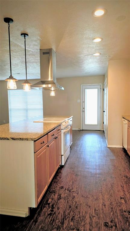 731 Leading Lane Allen, TX 75002 - Photo 2 of 18 a view of a kitchen with kitchen island a sink wooden floor and a counter top space