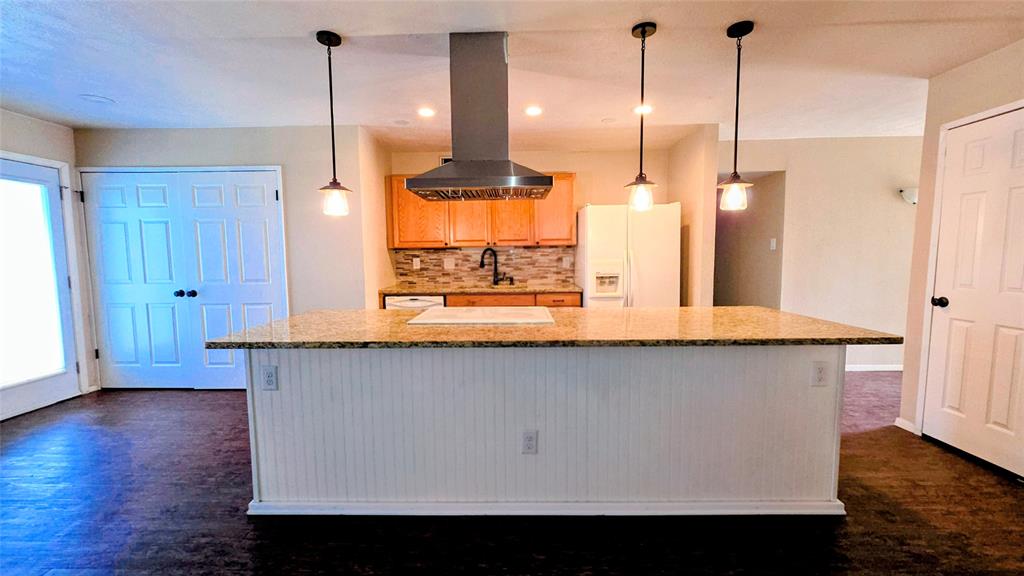 731 Leading Lane Allen, TX 75002 - Photo 3 of 18 a kitchen with stainless steel appliances granite countertop a sink a window and a wooden floor