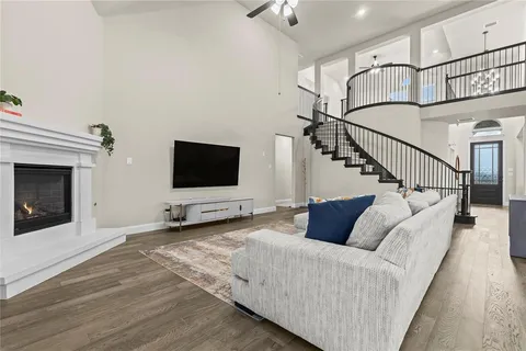 a spacious bedroom with a bed and a chandelier