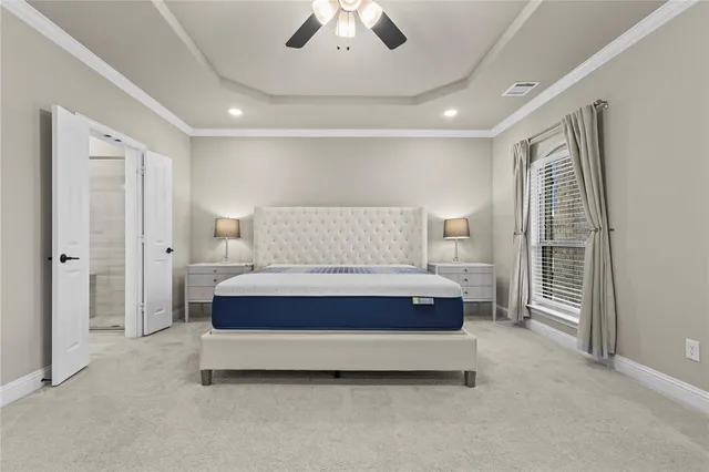 a spacious en suite bathroom with a double vanity sink a mirror and a