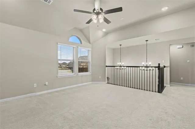 a view of an empty room with a window and closet