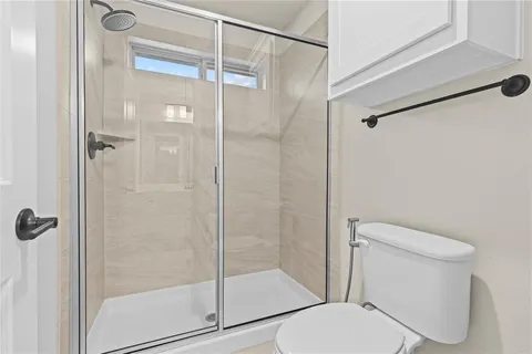 a room with a bed a chair and chandelier