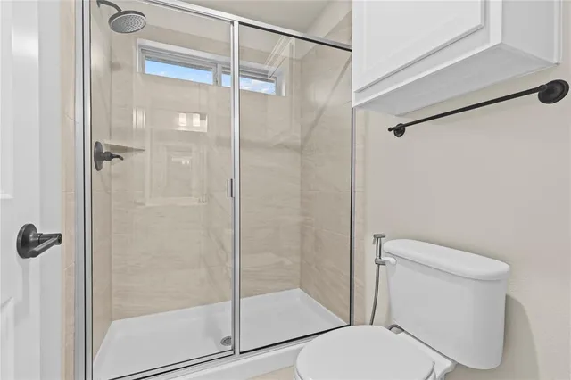 a room with a bed a chair and chandelier