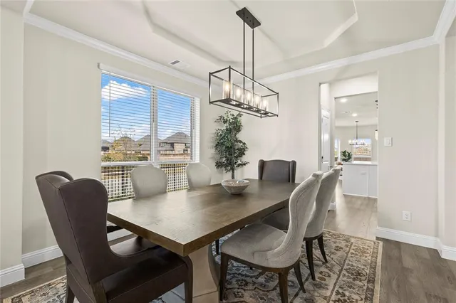 a view of a workspace with furniture and wooden floor