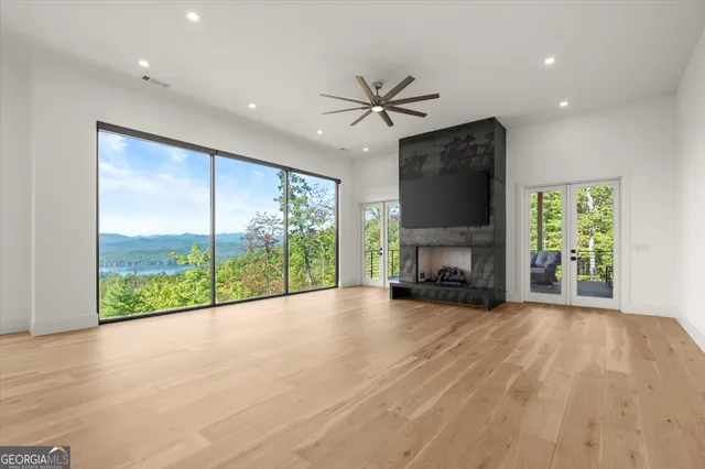 a large kitchen with stainless steel appliances a large counter top a stove and a refrigerator