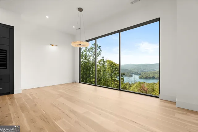 a living room with a bed furniture and a large window