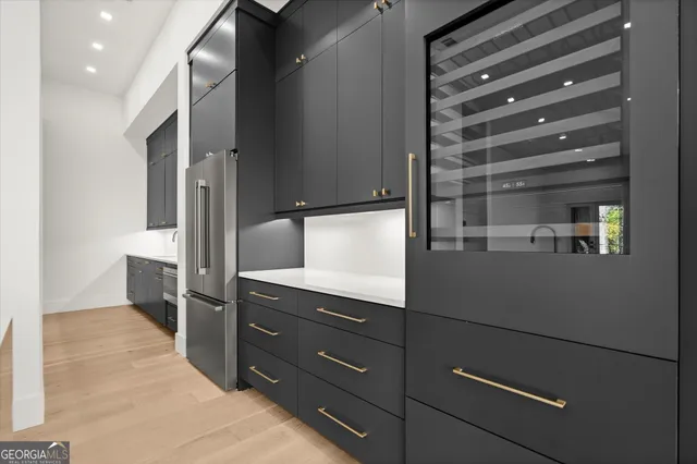 a view of a kitchen with a sink and a refrigerator