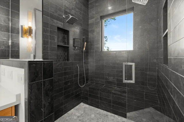 a bathroom with a granite countertop sink a toilet and shower