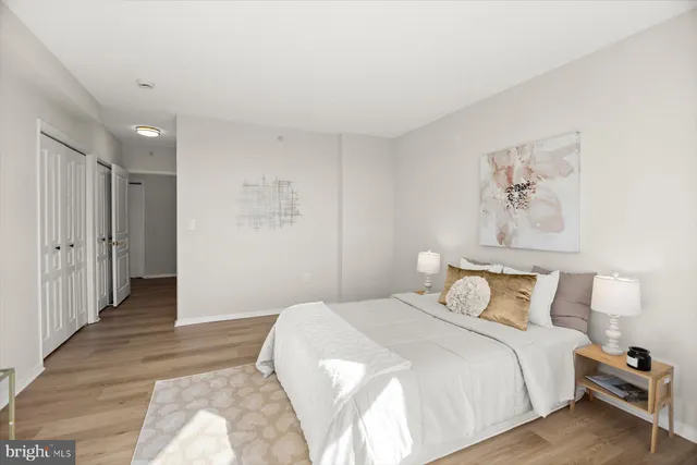 a bedroom with a large bed and a large window