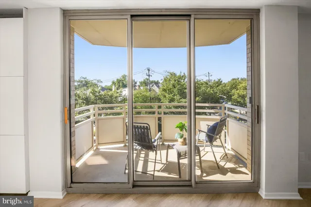 a living room with furniture potted plant and a large window