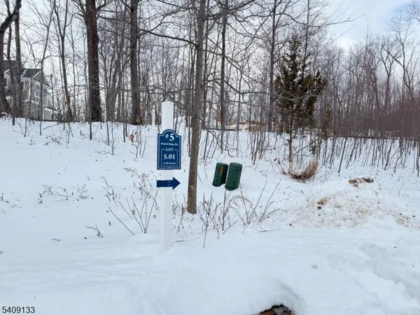 a view of white house with snow on the road
