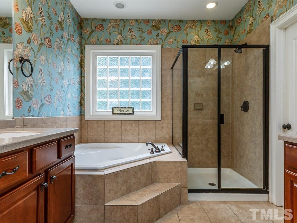 2233 Dunlin Lane Raleigh, NC 27614 - Photo 14 of 24 a spacious bathroom with a tub shower and window