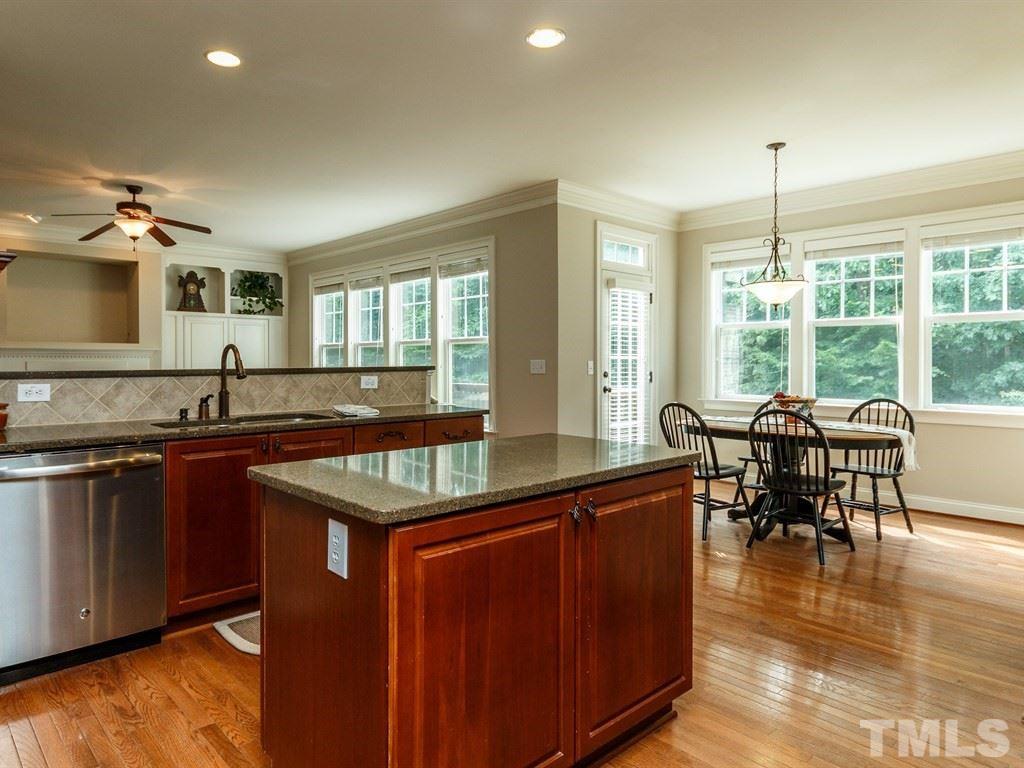 2233 Dunlin Lane Raleigh, NC 27614 - Photo 9 of 24 a kitchen with center island and stainless steel appliances