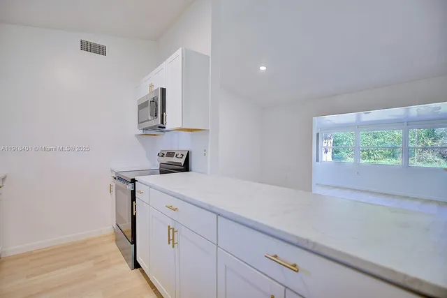 a kitchen with a sink and a stove top oven