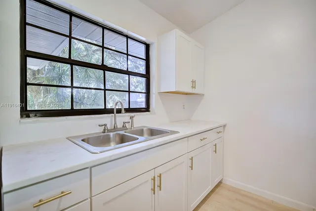 a kitchen with a sink and a stove top oven