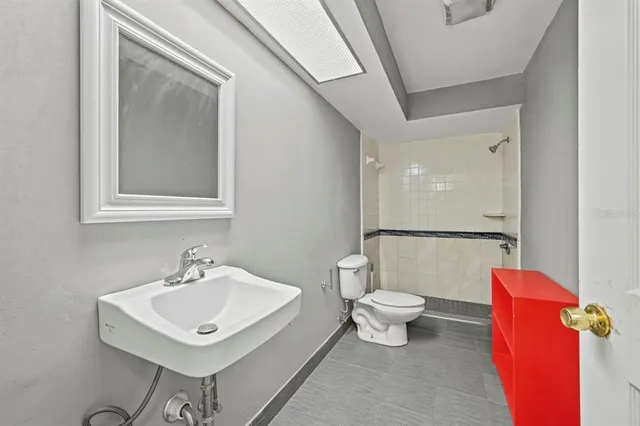 a white toilet sitting next to a bathroom sink