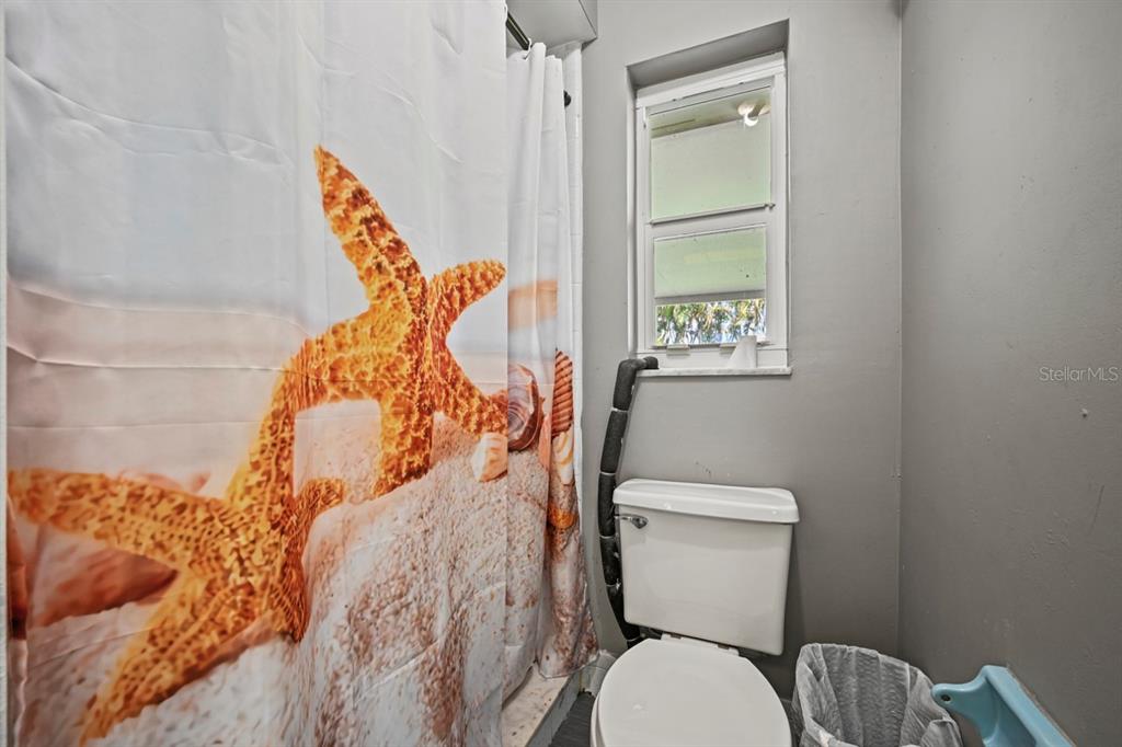 101 St Andrews Boulevard Naples, FL 34113 - Photo 12 of 34 a white toilet sitting next to a bathroom sink