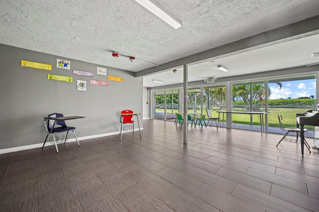 101 St Andrews Boulevard Naples, FL 34113 - Photo 15 of 34 a living room with furniture and a large window