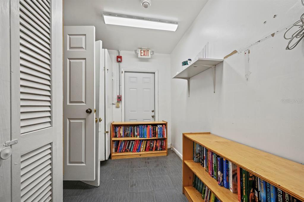 101 St Andrews Boulevard Naples, FL 34113 - Photo 18 of 34 a view of a bedroom with baby crib and furniture