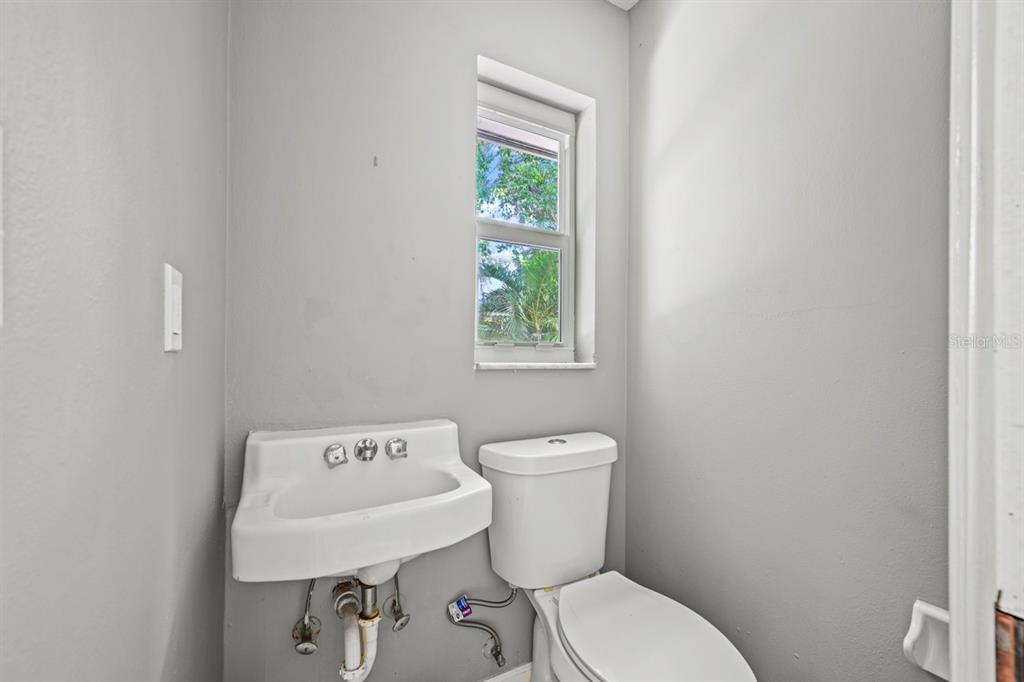 101 St Andrews Boulevard Naples, FL 34113 - Photo 19 of 34 a white toilet sitting next to a bathroom sink
