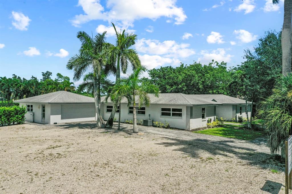 101 St Andrews Boulevard Naples, FL 34113 - Photo 2 of 34 a front view of a house with a garden