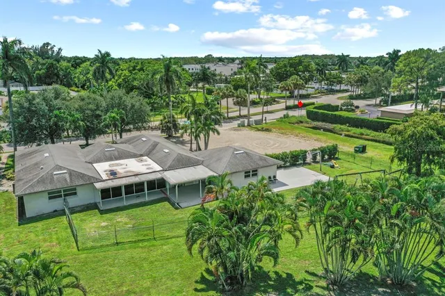 an aerial view of residential houses with outdoor space and street view