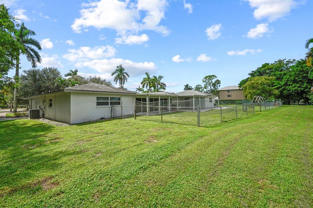 101 St Andrews Boulevard Naples, FL 34113 - Photo 28 of 34 a view of a house with a backyard and a garden