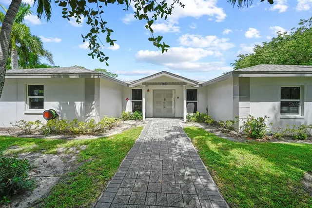a front view of house with yard and green space