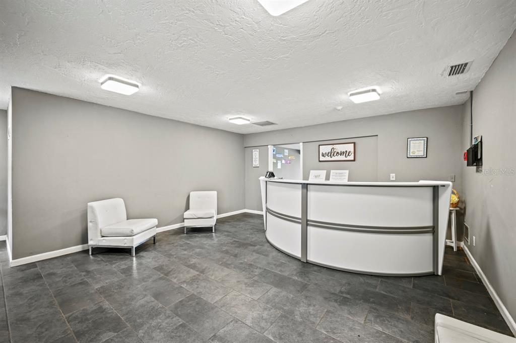 101 St Andrews Boulevard Naples, FL 34113 - Photo 4 of 34 a living room with a sink and a refrigerator