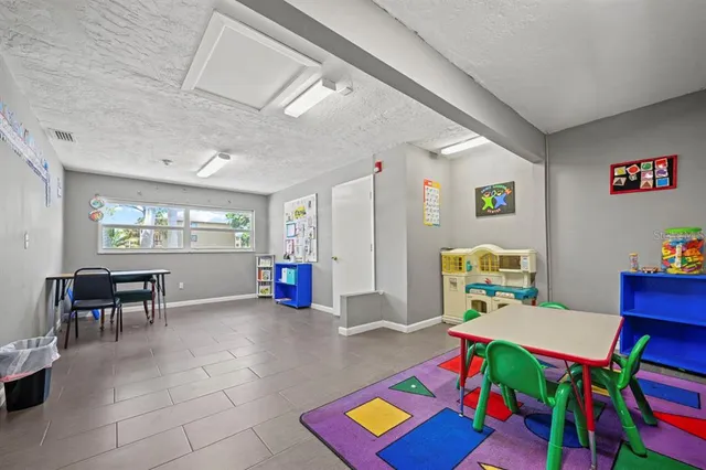 a reading room with furniture a window and a bookshelf
