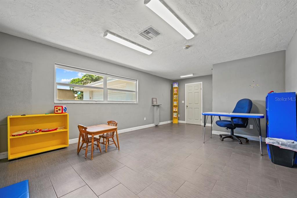 101 St Andrews Boulevard Naples, FL 34113 - Photo 7 of 34 a reading room with furniture and a window