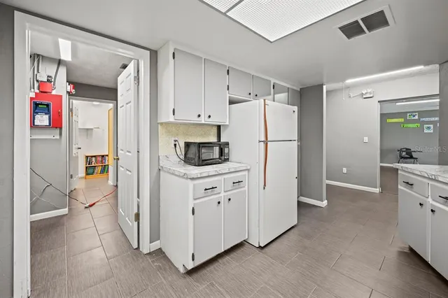 a kitchen with stainless steel appliances a refrigerator sink and cabinets
