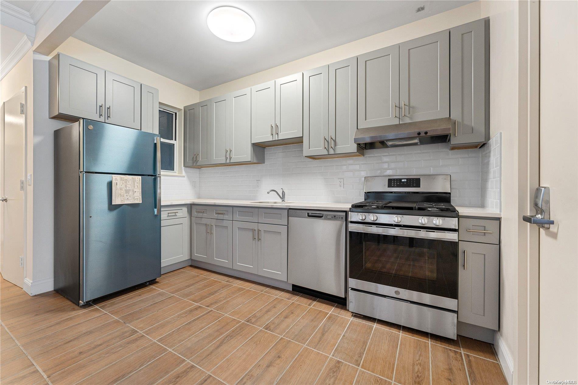 5112 Post Road Bronx, NY 10471 - Photo 11 of 35 a kitchen with stainless steel appliances granite countertop a stove a refrigerator and a microwave