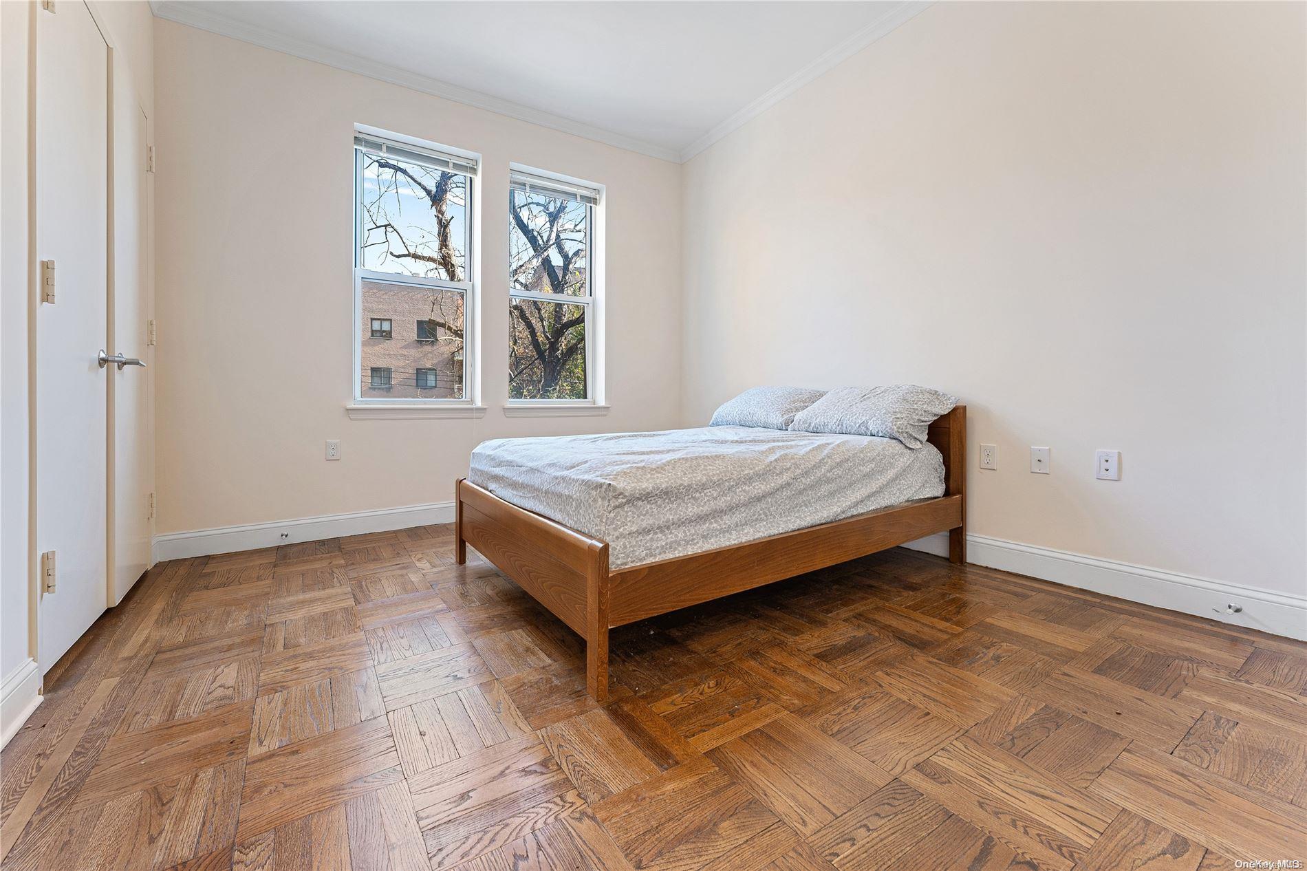 5112 Post Road Bronx, NY 10471 - Photo 13 of 35 a bed sitting in a bedroom next to a window