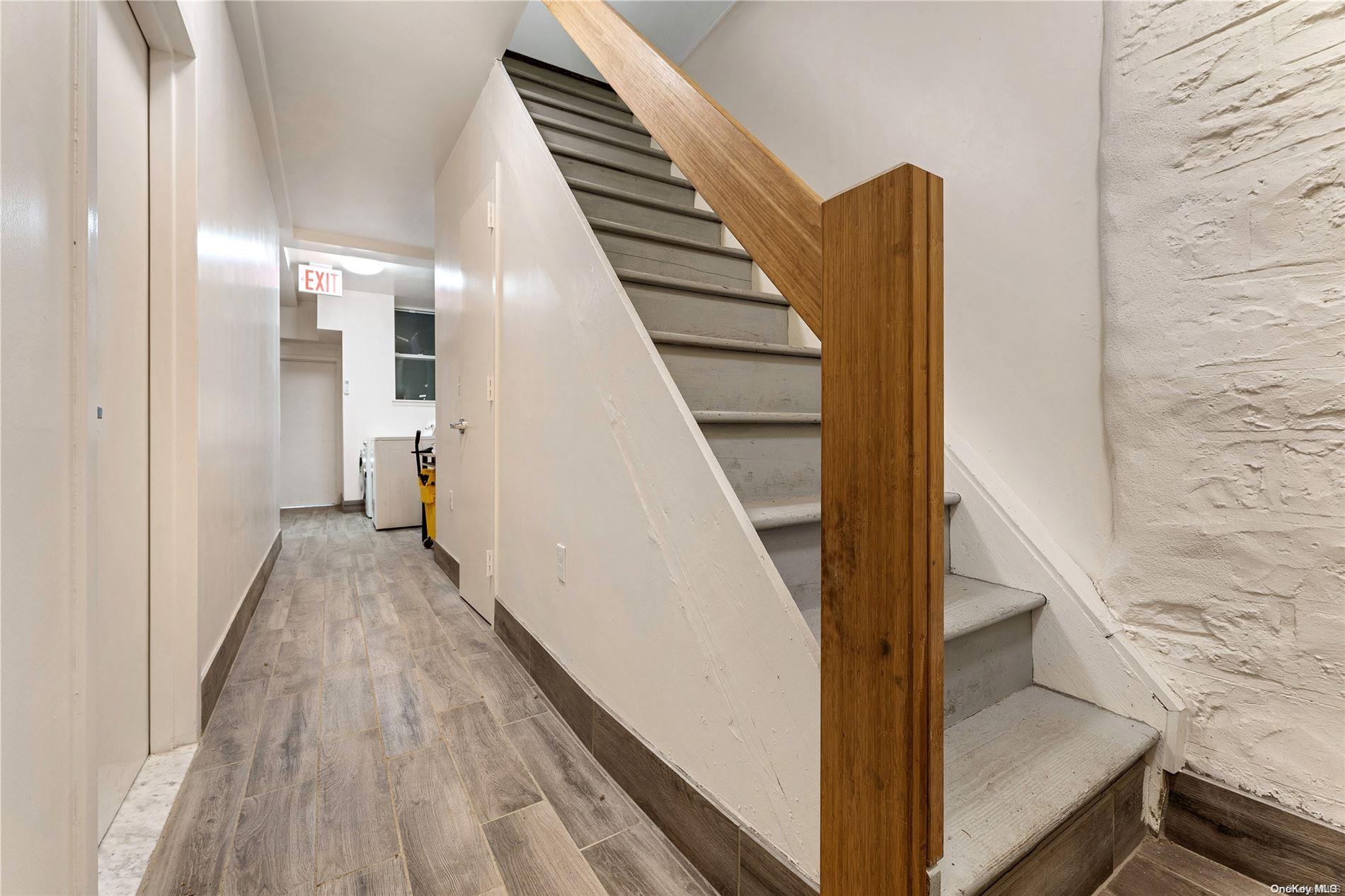 5112 Post Road Bronx, NY 10471 - Photo 19 of 35 a view of a hallway with wooden floor and staircase